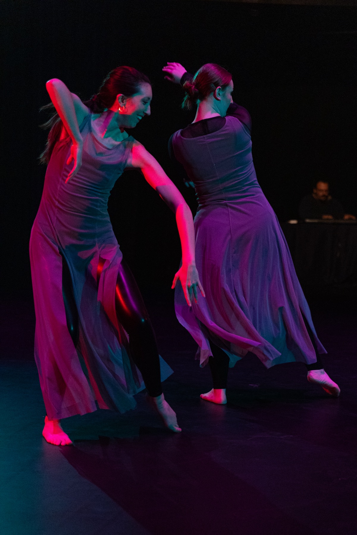 Two dancers in flowing dresses under pink light at Fall Dances 2025